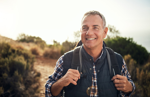 Shot of a mature man hiking through the mountains